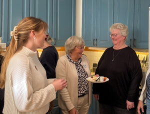 Tre kvinnor minglar och skrattar. 